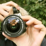 Hands focusing a camera