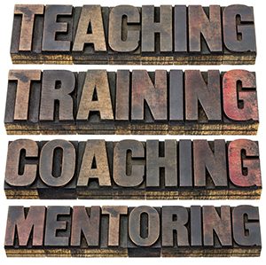teaching, training, coaching and mentoring - a collage of isolated words in vintage letterpress wood type with ink patina