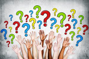 Multi-ethinic arms outstretched to ask questions.