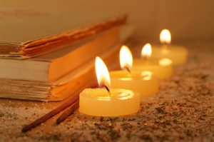 Esoteric atmosphere created with candles, old books and incense