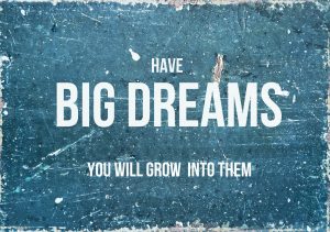 Have big dreams, you will grow into them inspirational quotation on blue background.